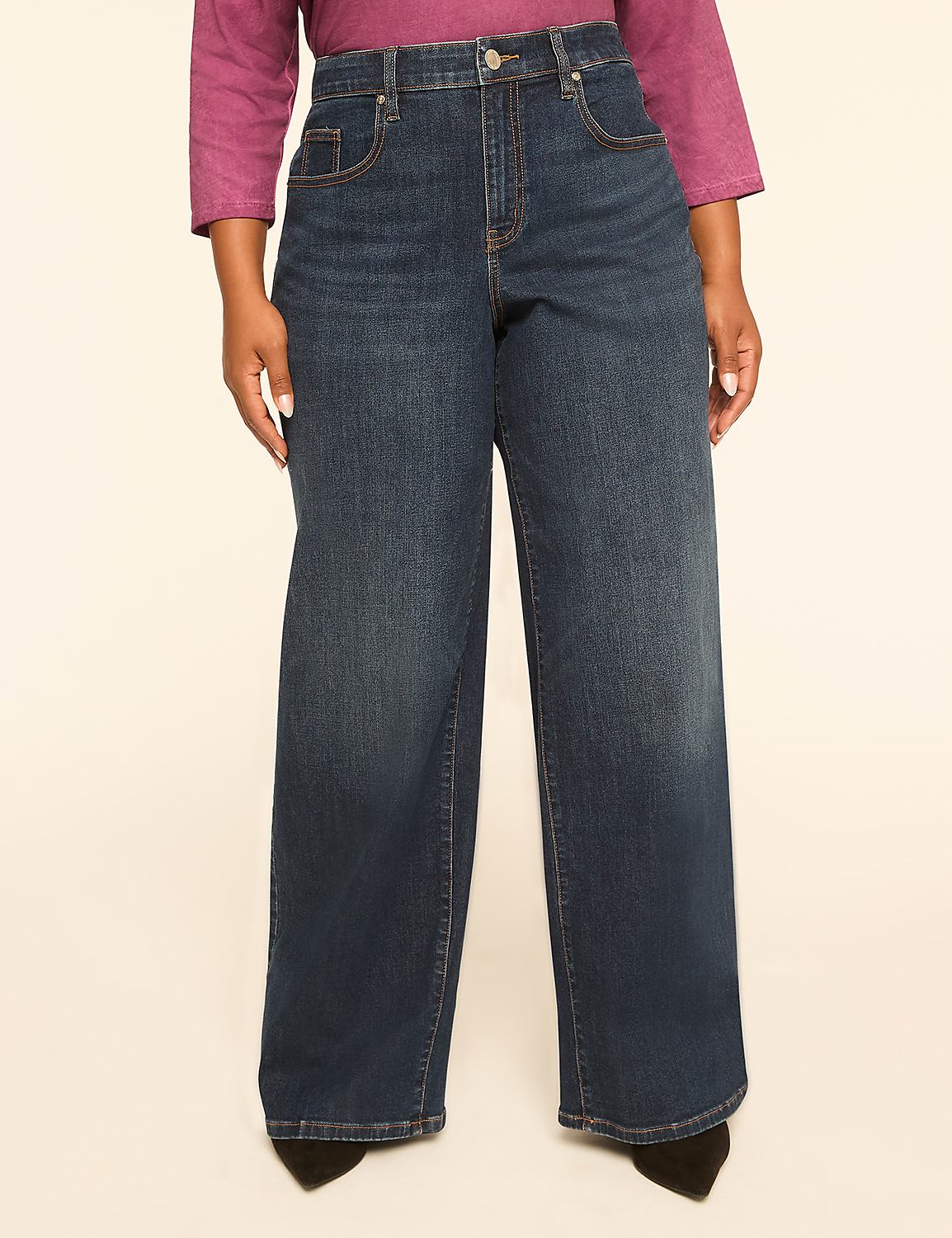 A person wearing dark wash wide-leg jeans stands against a plain, light-colored background. Product Image 1