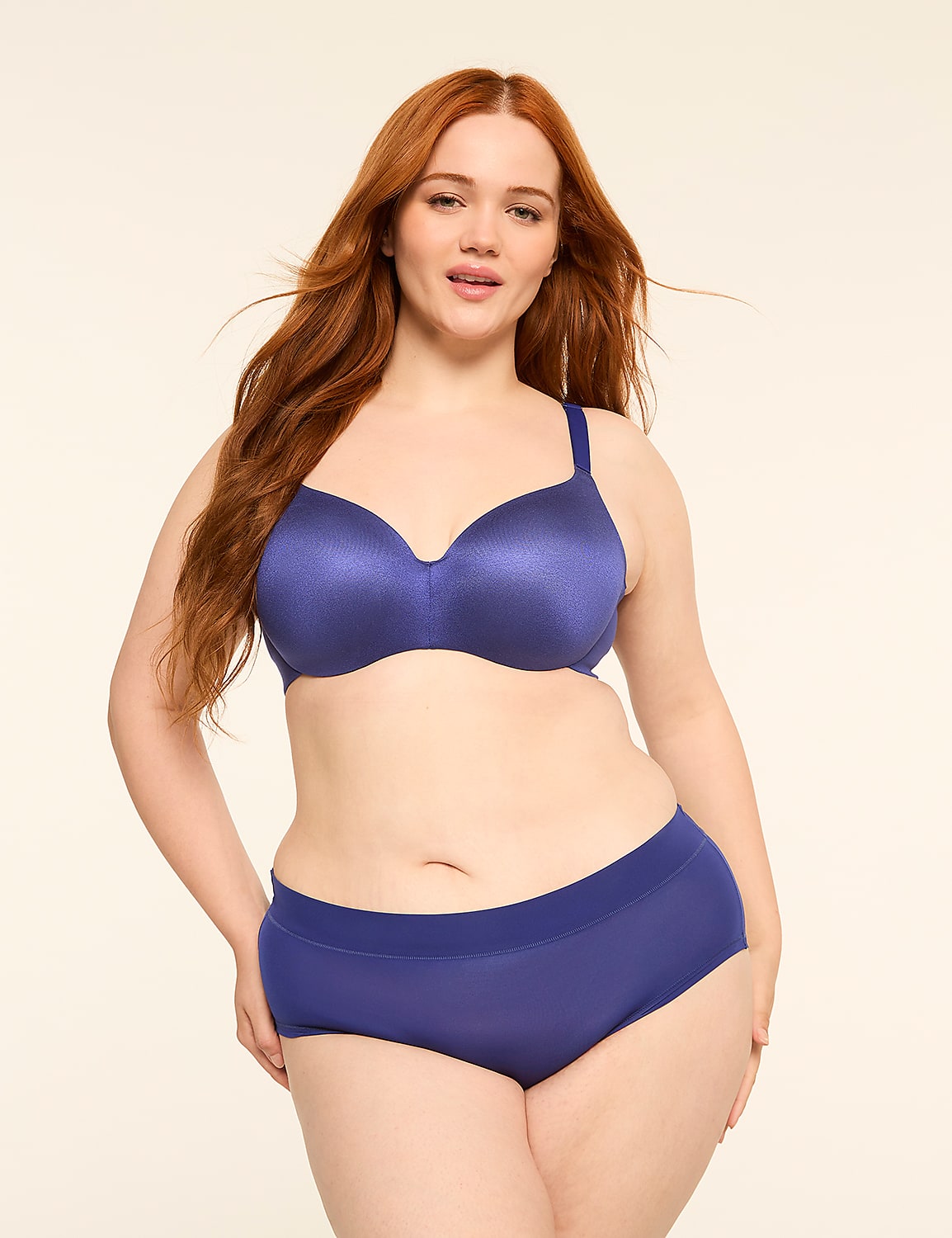 A woman with long red hair poses in a blue bra and underwear against a plain, light-colored background. Product Image 4