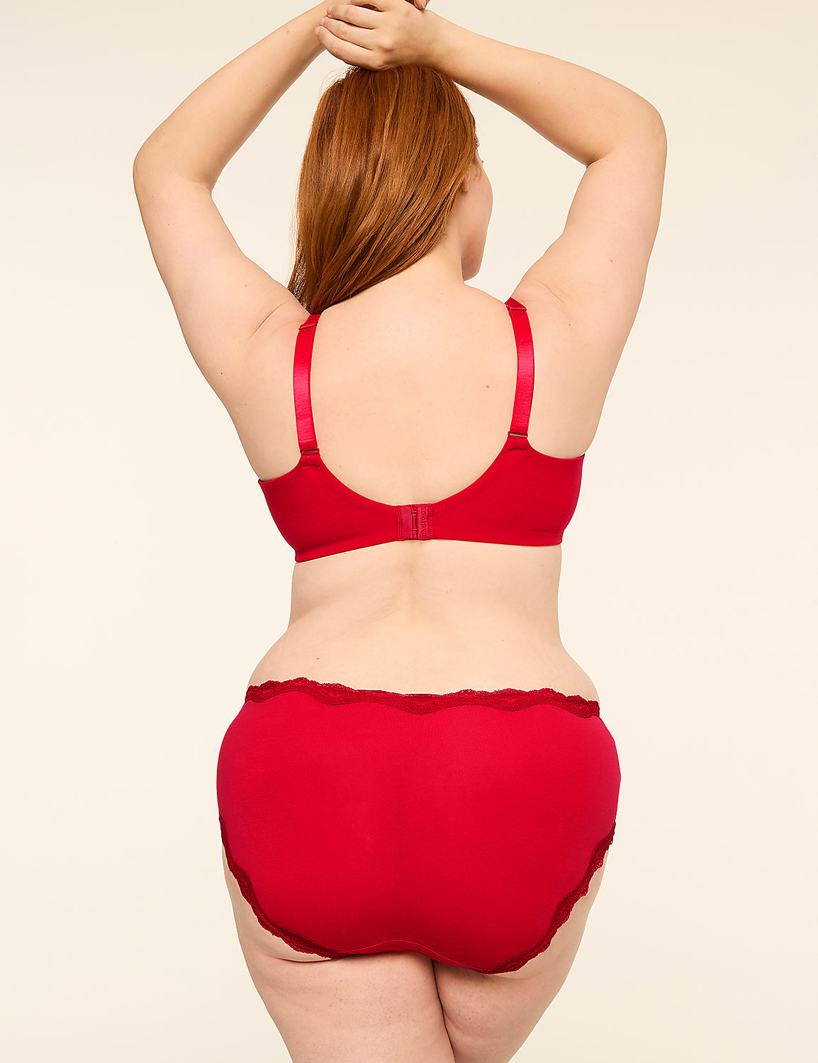 A woman with red hair, seen from behind, wears a red bra and matching underwear, standing against a plain, light-colored background. Product Image 2