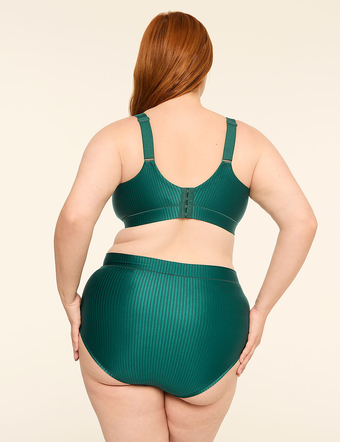 A woman with red hair stands with her back to the camera, wearing a green ribbed bra and high-waisted underwear against a plain, light-colored background. Product Image 2