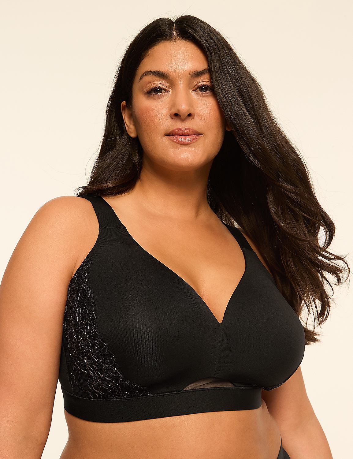 A woman with long dark hair wears a black bra with lace detailing on the side, against a plain, light-colored background. Product Image 1