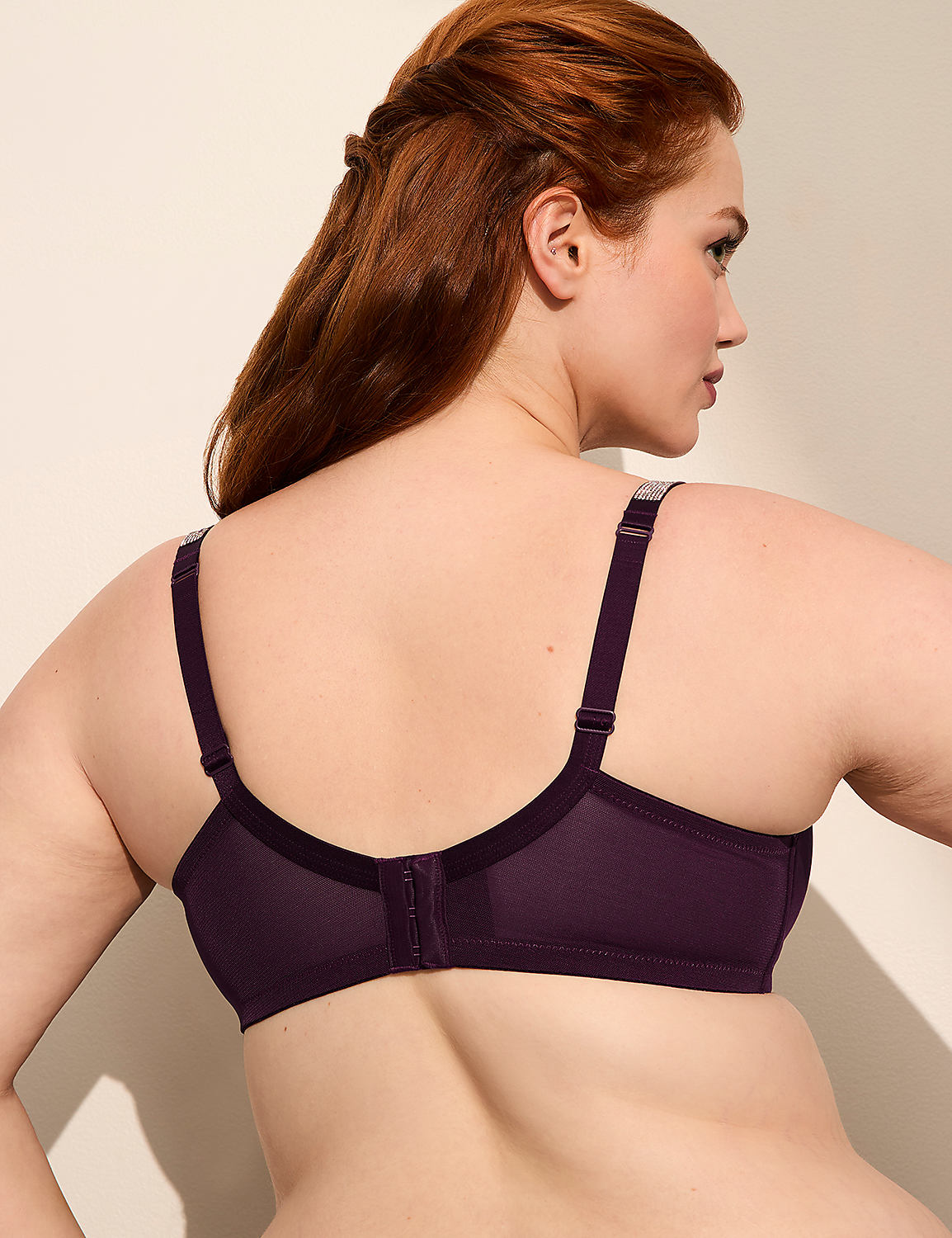 A woman with auburn hair wears a purple bra, with the background a plain, light-colored wall. Product Image 3