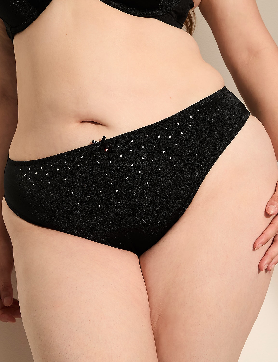 A close-up of a person's torso in black underwear with a subtle sparkle, against a plain background. Product Image 1