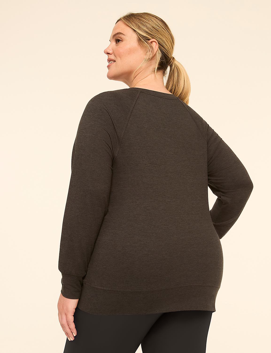 A woman in a dark grey sweatshirt and blue plaid pants stands against a plain, light-colored background. Product Image 2