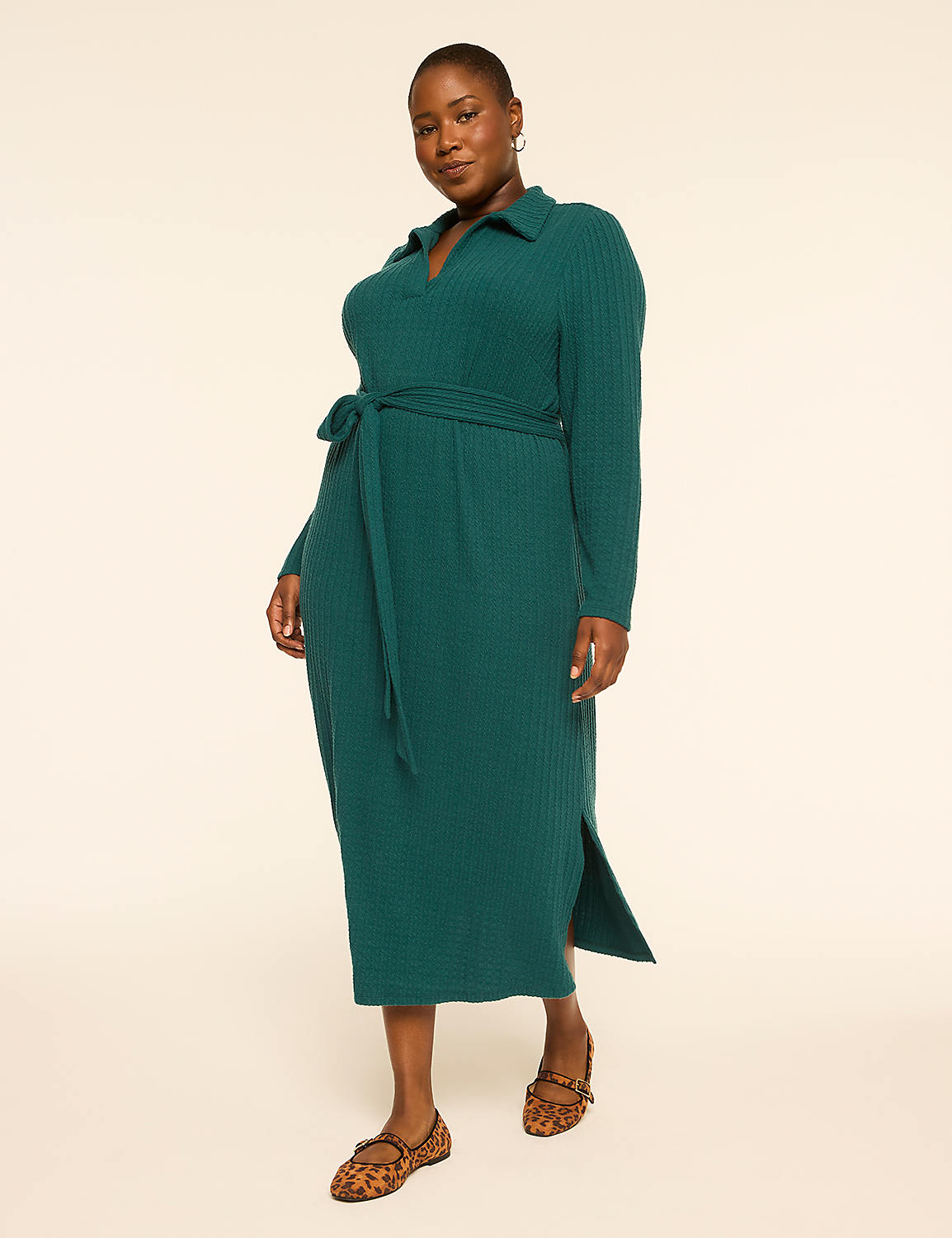 A woman in a teal collared dress with a belted waist and leopard print flats stands against a plain, light-colored background. Product Image 1