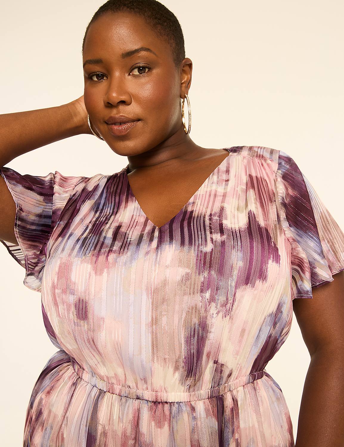 A woman in a flowing, watercolor-patterned dress poses against a plain, light-colored background. Product Image 3