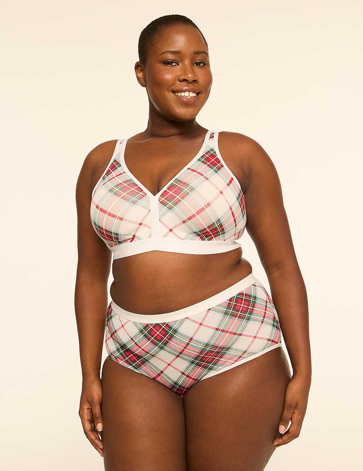 A smiling woman in a plaid bra and underwear stands against a plain, light-colored background. Product Image 4