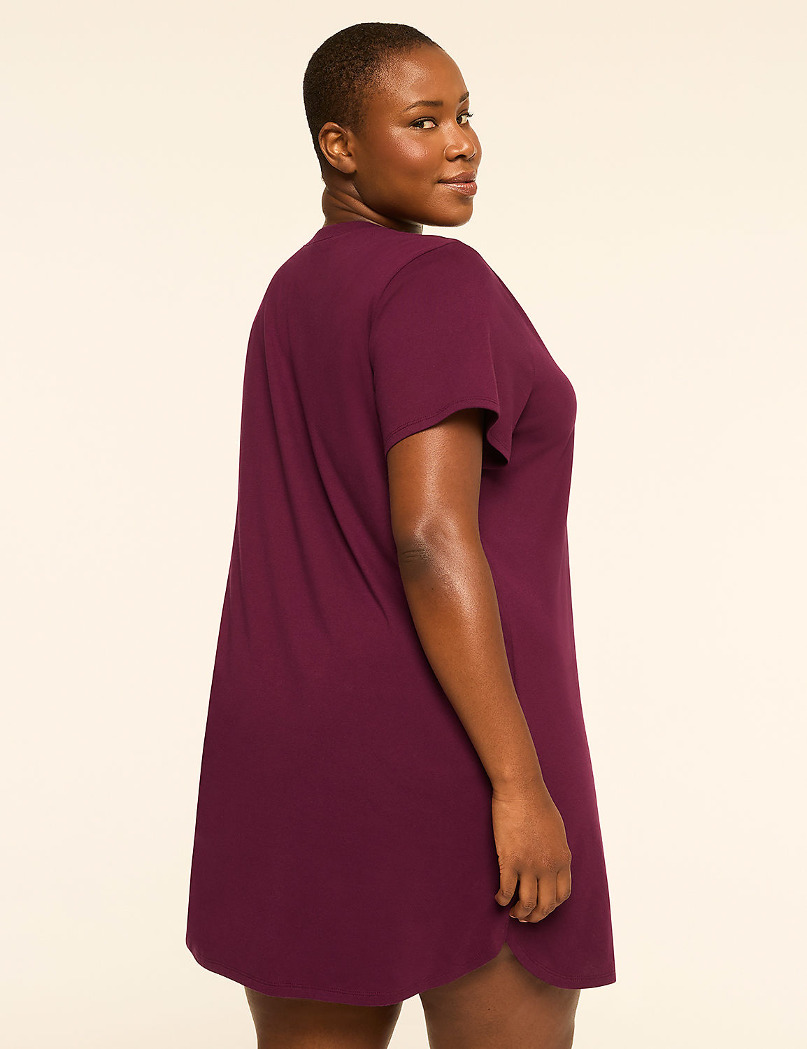 A woman in a plum-colored t-shirt dress stands against a plain, light-colored background. Product Image 2