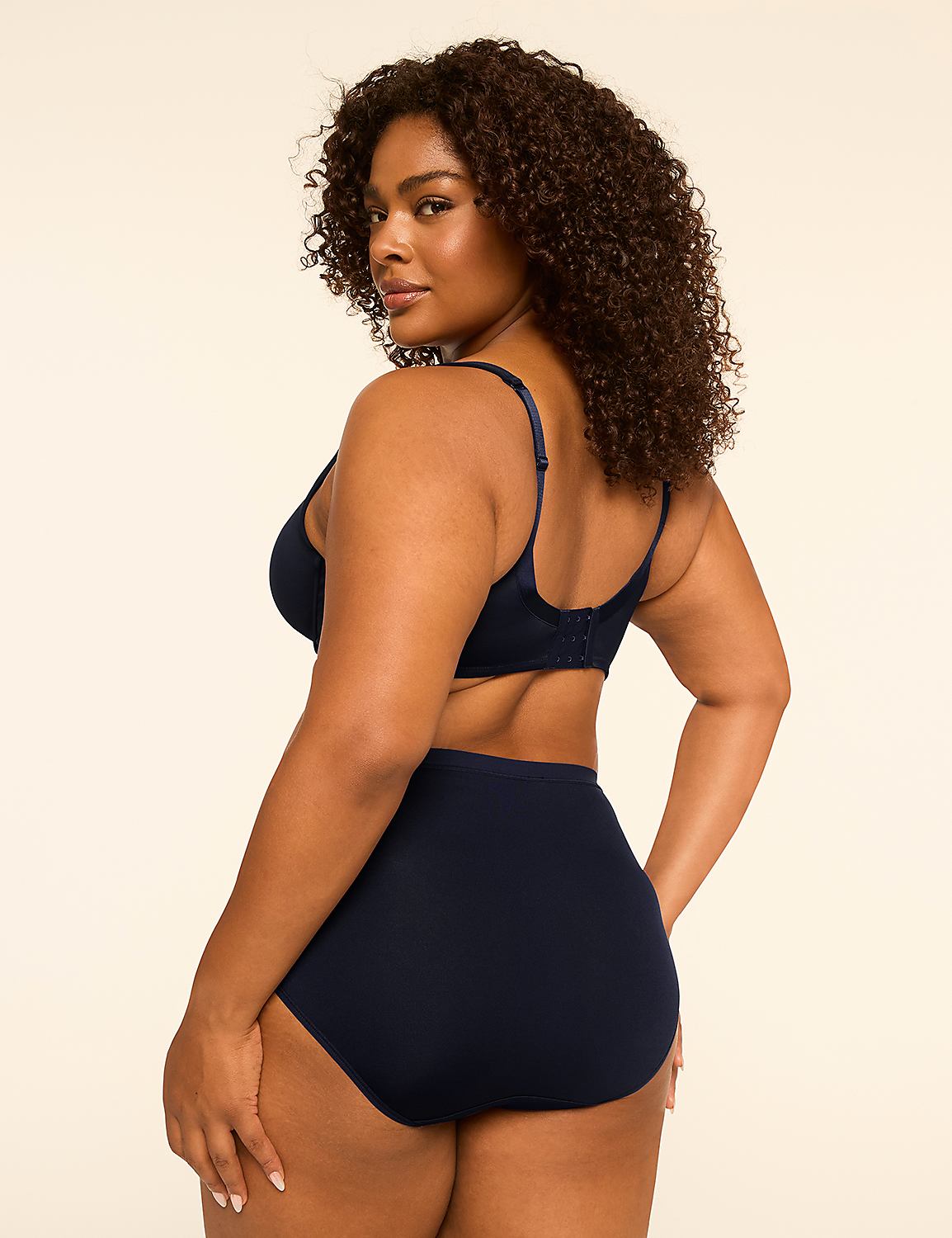 A woman in navy blue lingerie stands against a plain, light-colored background. Product Image 2