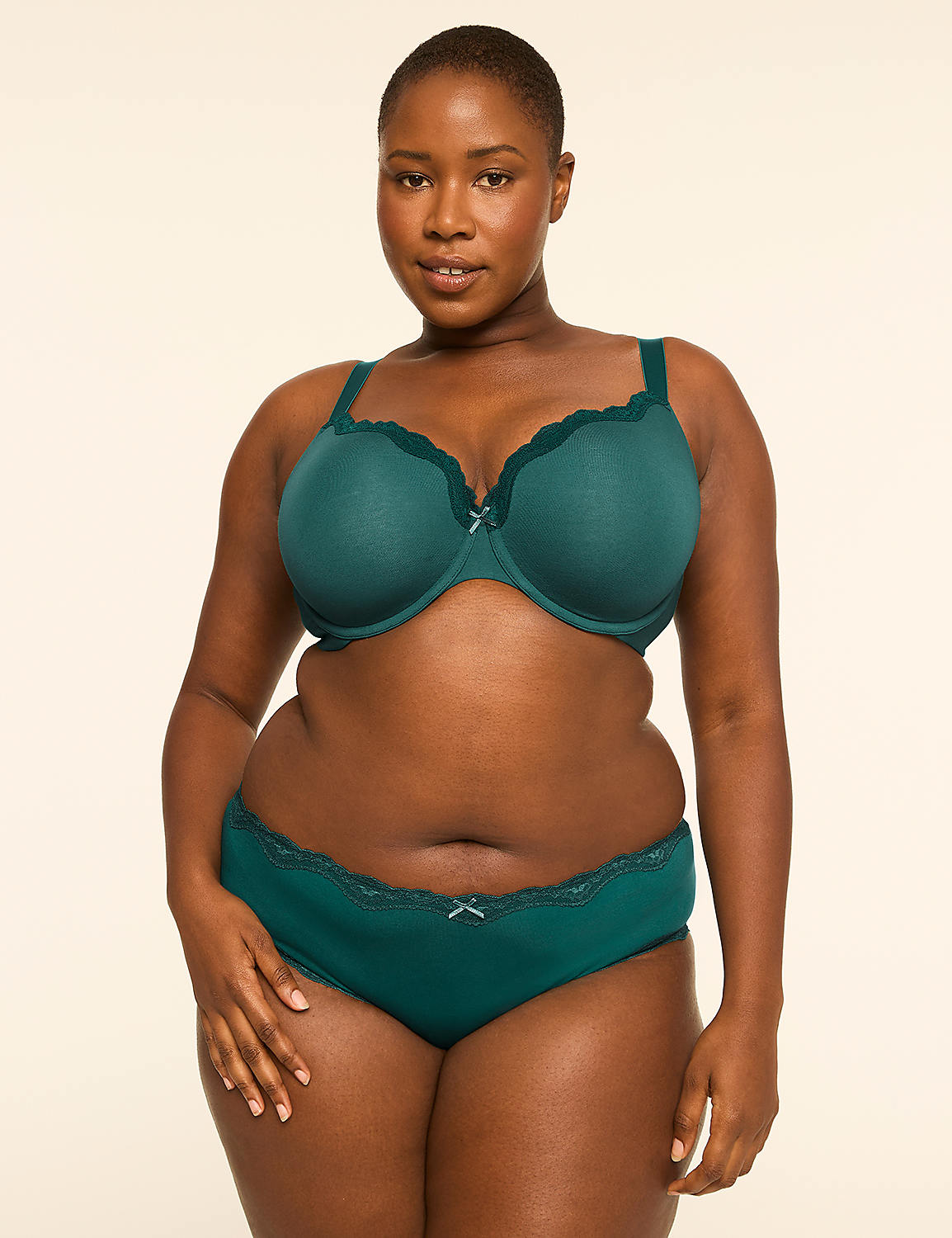 A woman in a teal bra and underwear stands against a plain, light background. Product Image 4