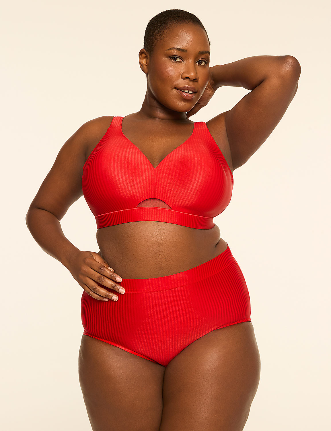 A woman in a red ribbed bikini poses against a plain, light-colored background. Product Image 4