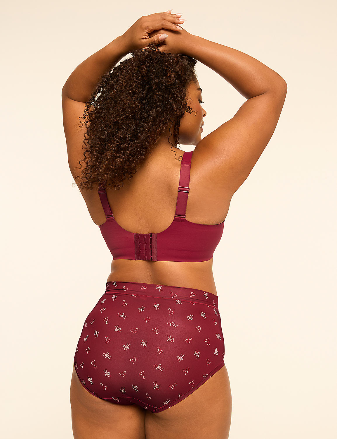A woman in a maroon bra and matching patterned underwear stands with her back to the viewer against a plain, light-colored background. Product Image 2