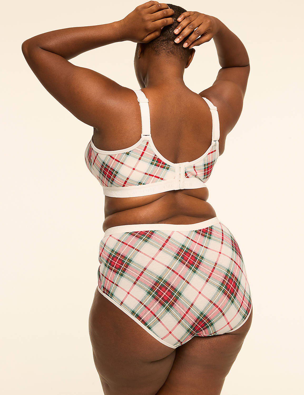 A woman in a plaid bra and underwear stands with her hands behind her head against a plain, light-colored background. Product Image 2