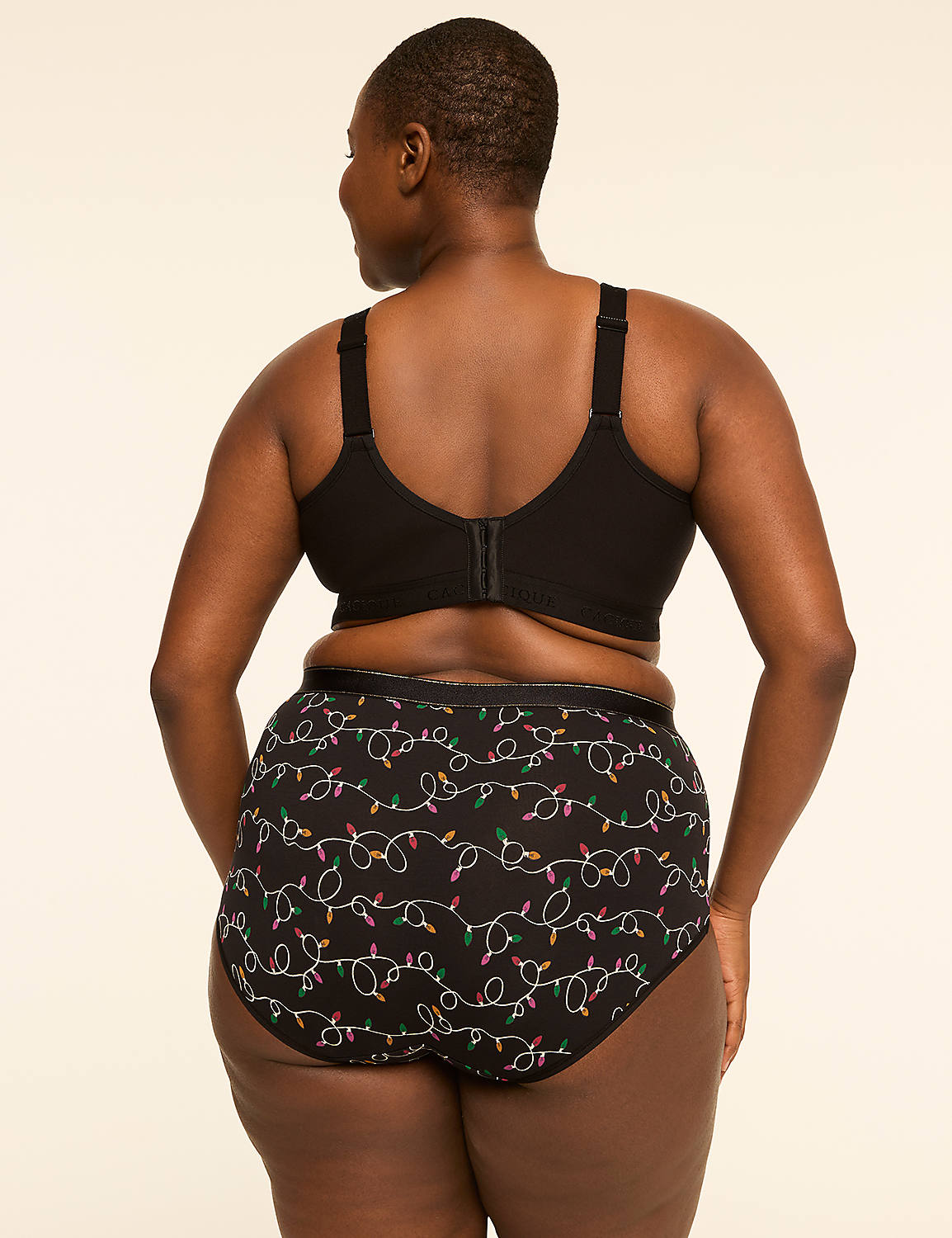 A woman in a black bra and patterned underwear stands against a plain, light-colored background. Product Image 2