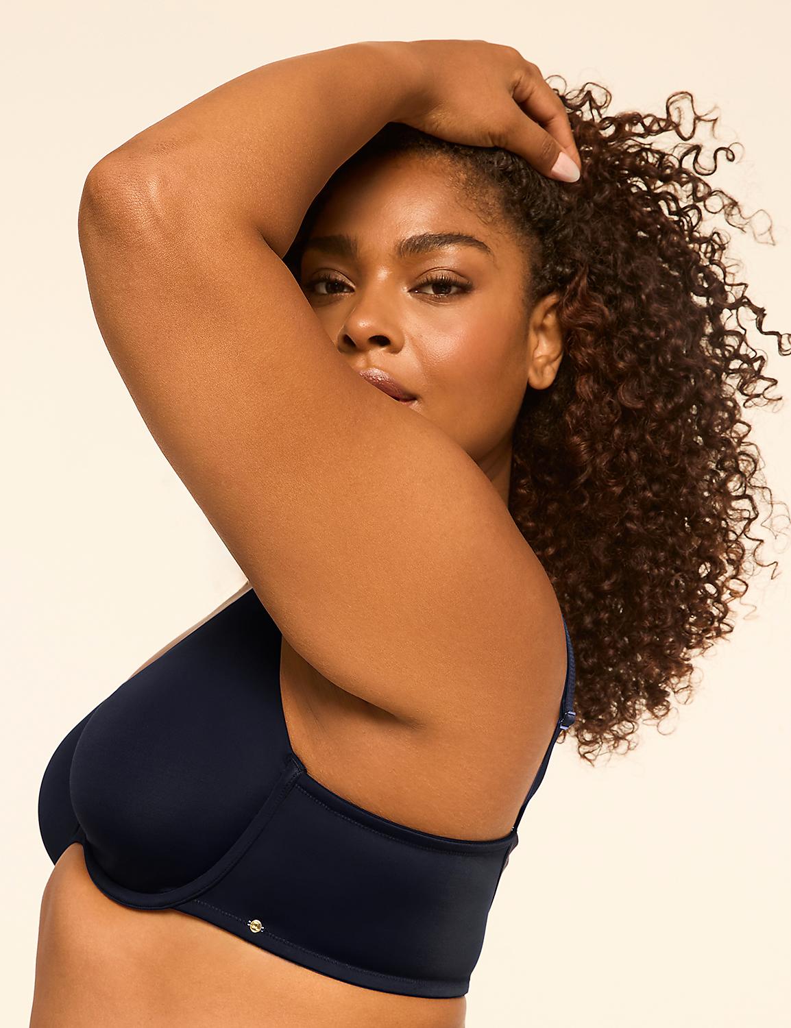 A woman with curly dark hair and dark skin poses in a navy blue bra against a plain beige background. Product Image 3