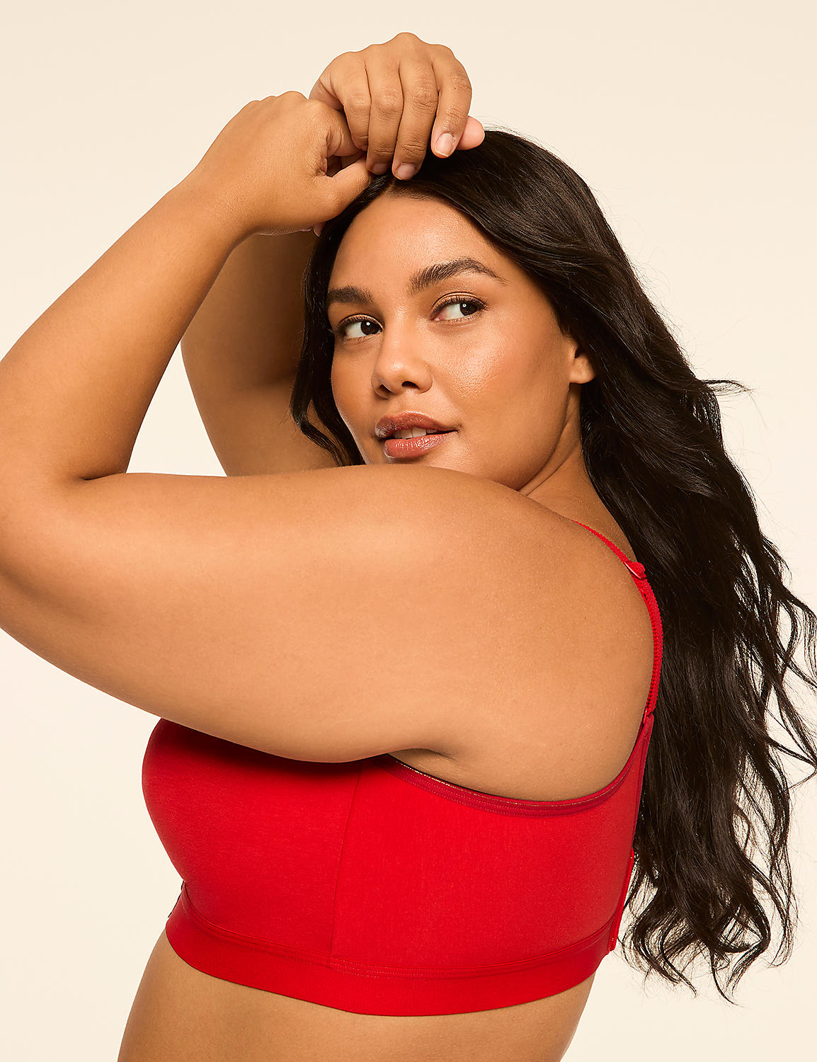 A woman in a red top poses with her arms raised against a plain, light background. Product Image 3
