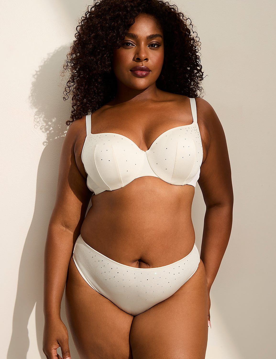A woman in a white bra and underwear stands against a plain, light-colored wall with shadows. Product Image 3
