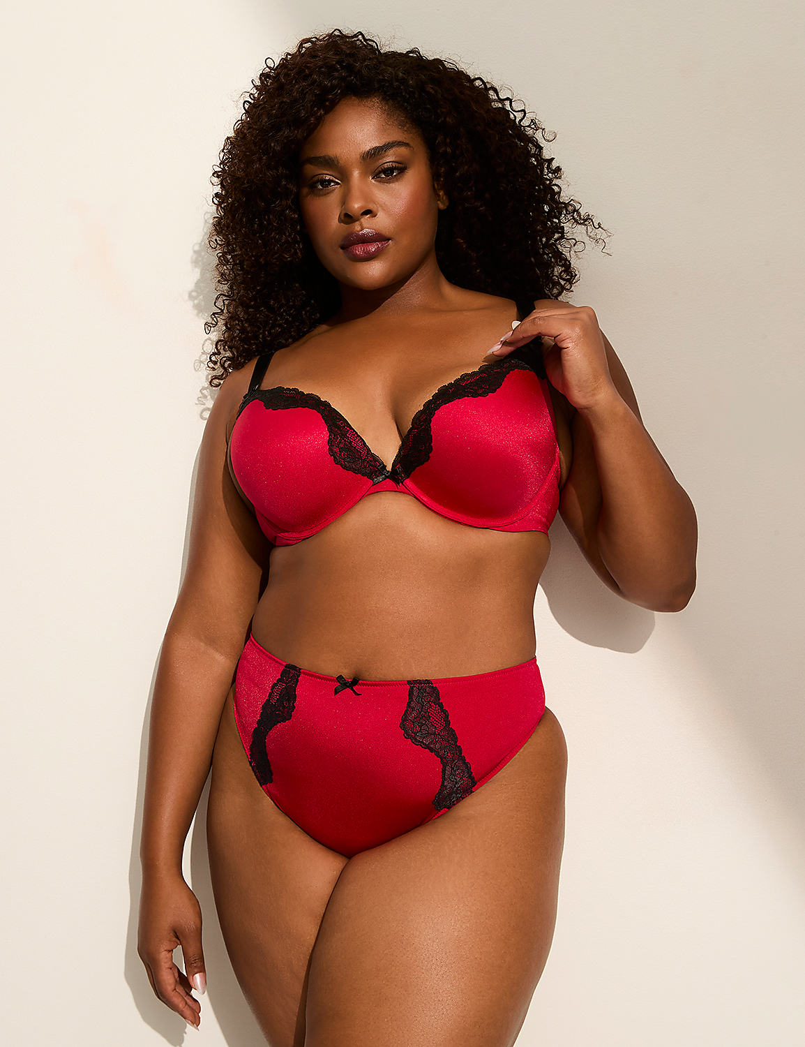 A woman in red lingerie stands against a plain, light-colored wall. Product Image 3