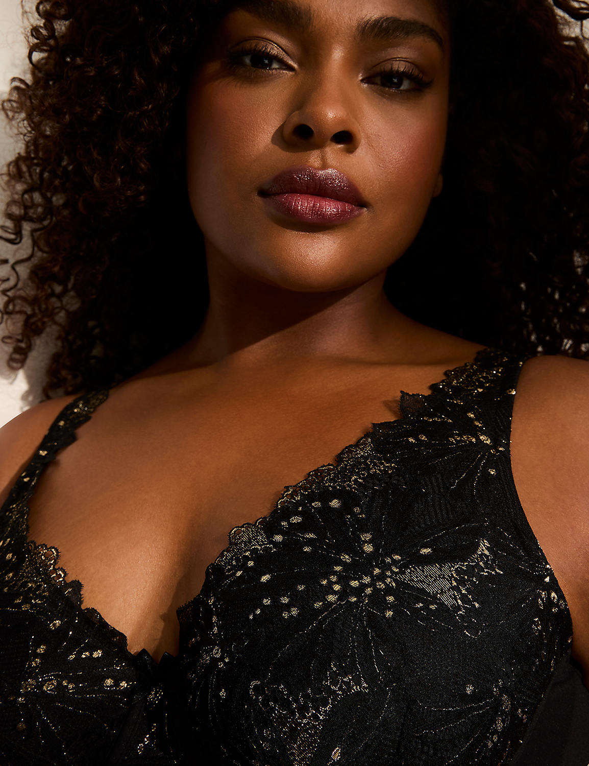 A close-up of a woman's face and chest in the foreground, with a blurred, light-colored background. Product Image 3