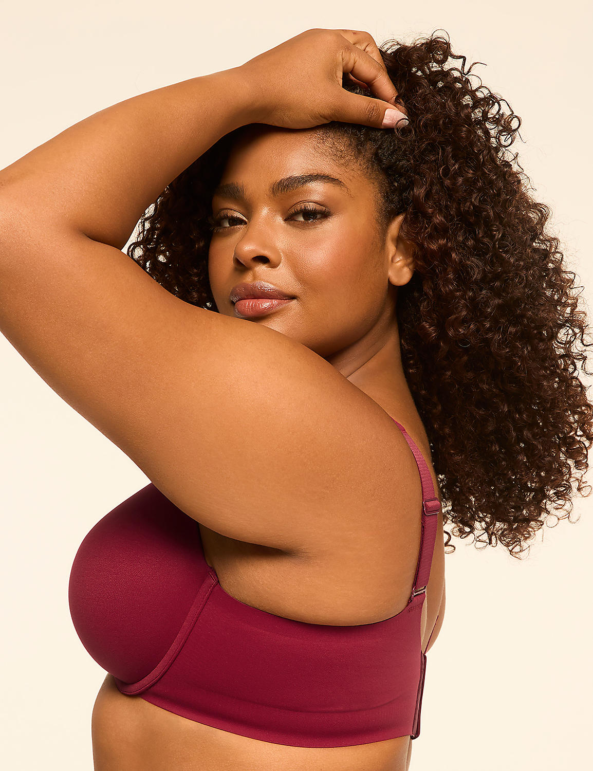 A woman with curly dark hair poses in a maroon bra against a plain beige background. Product Image 3