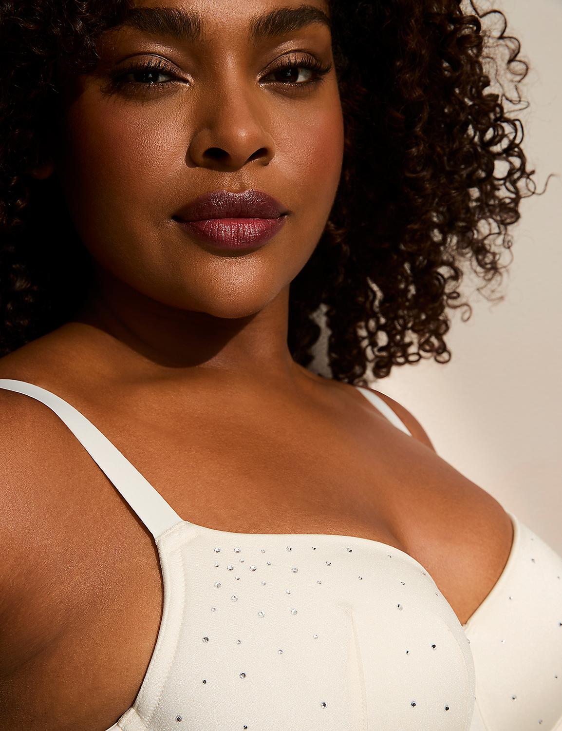 A woman with curly hair and dark lipstick is shown in the foreground, wearing a white bra adorned with small rhinestones, against a softly lit, neutral background. Product Image 2