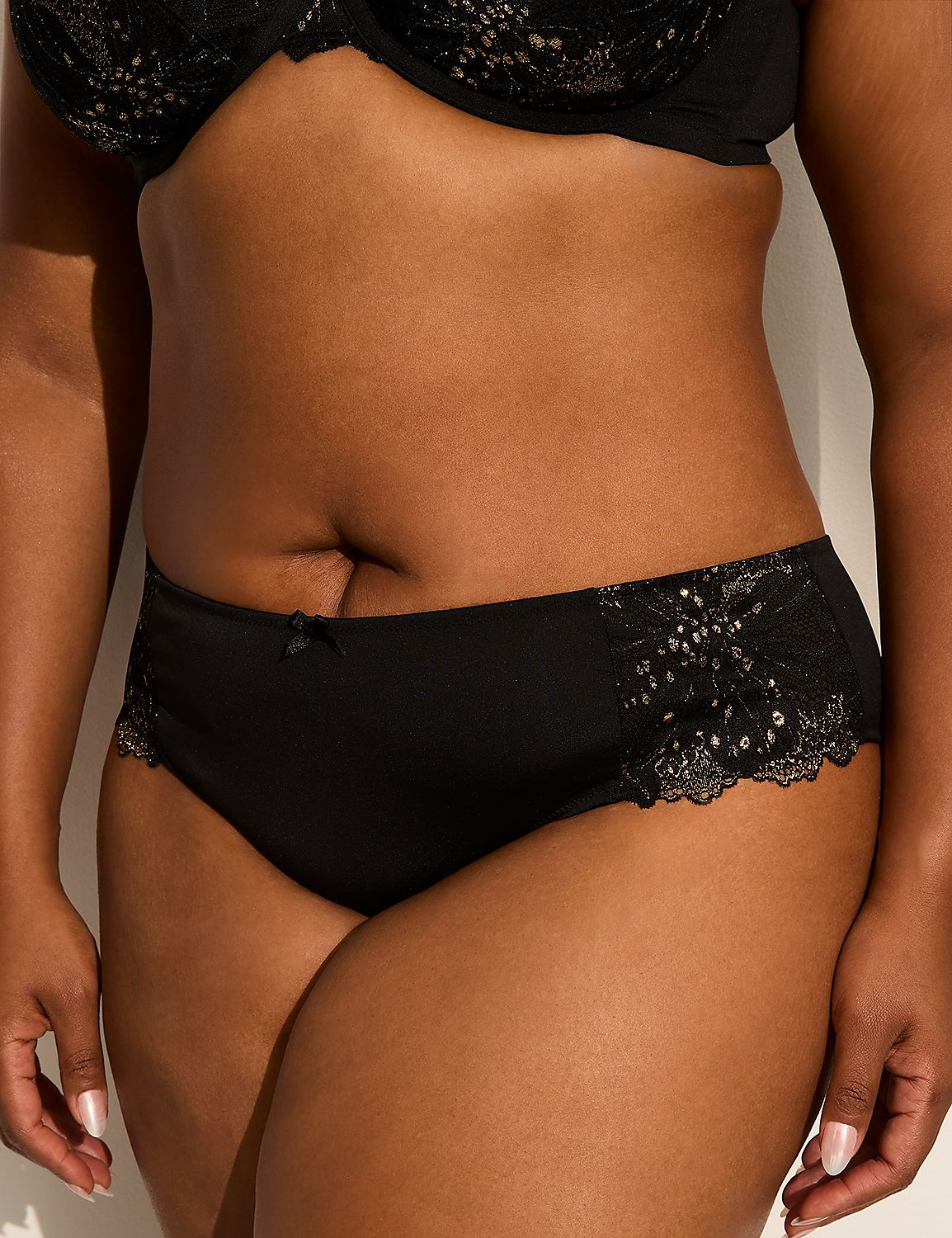 A person in black lace-trimmed underwear stands against a plain white background. Product Image 1