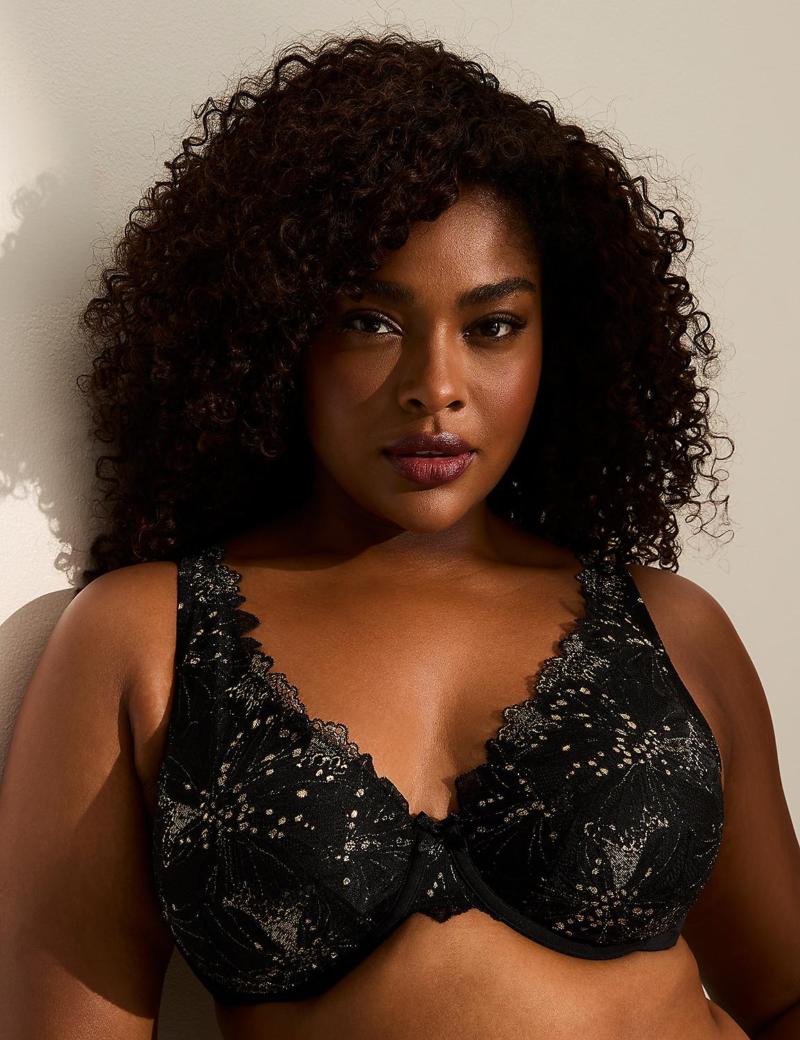 A woman with curly dark hair wears a black lace bra in the foreground, with a plain, light-colored wall behind her. Product Image 1