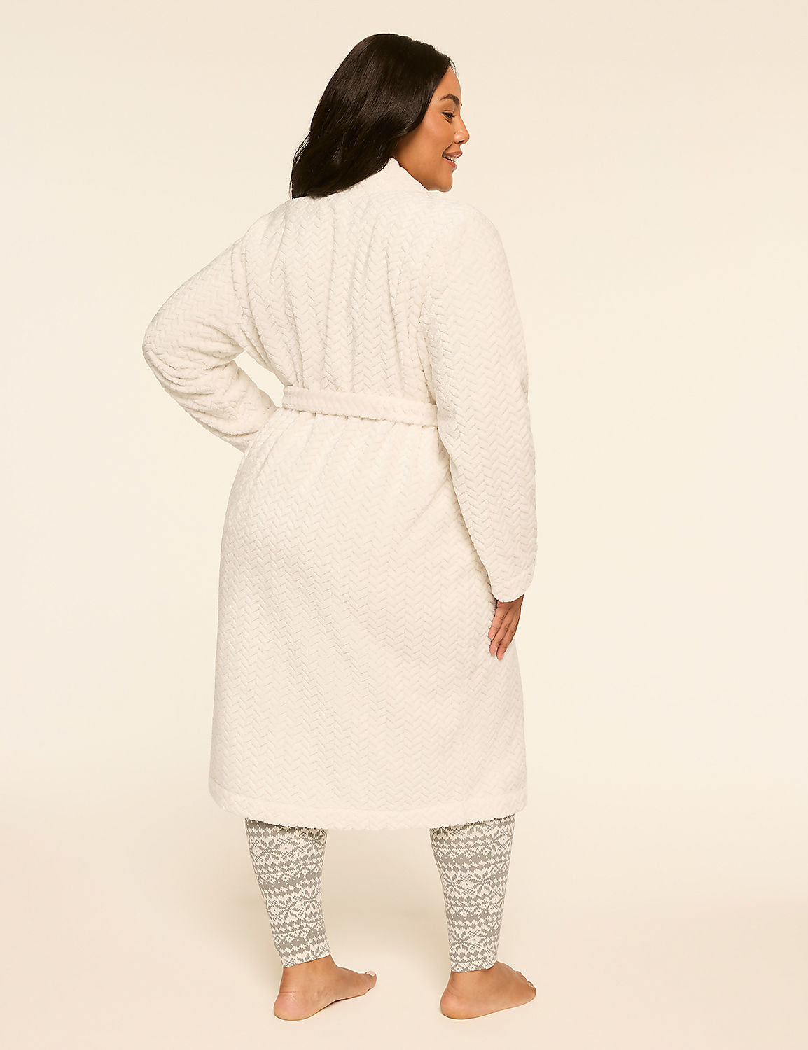 A woman in a white robe and patterned leggings stands against a plain, light-colored background. Product Image 2