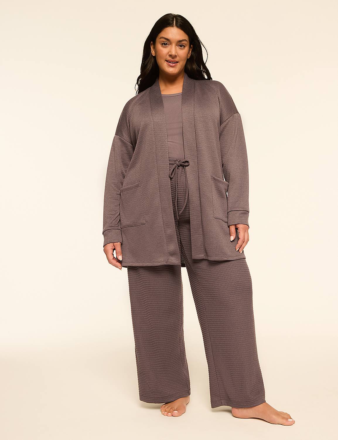 A woman in a cozy purple loungewear set stands against a plain, light-colored background. Product Image 3