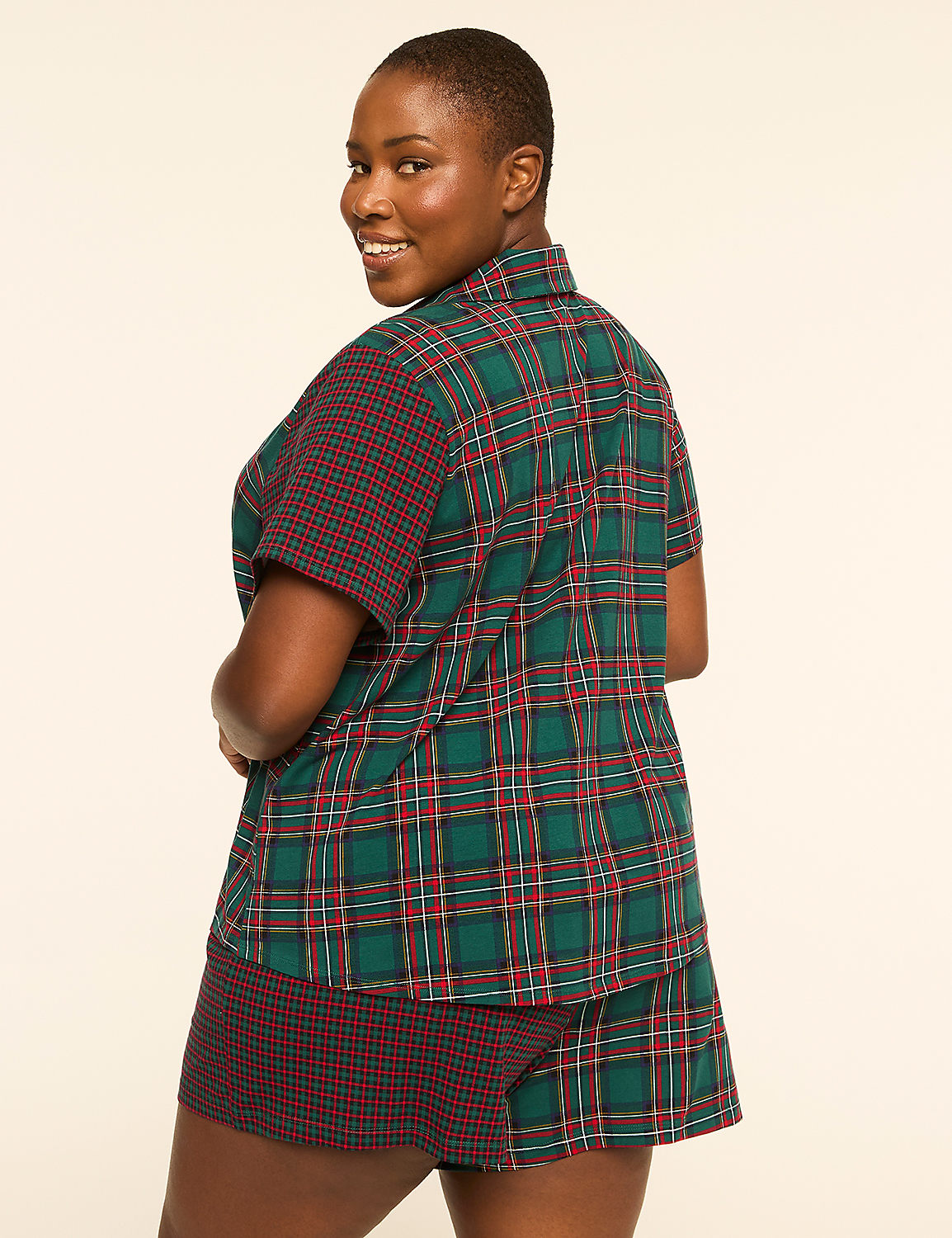 A woman in plaid pajamas smiles over her shoulder against a plain, light background. Product Image 2