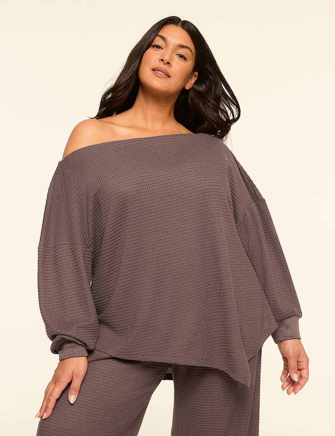 A woman in a waffle-knit off-the-shoulder top and matching pants poses against a plain, light-colored background. Product Image 1