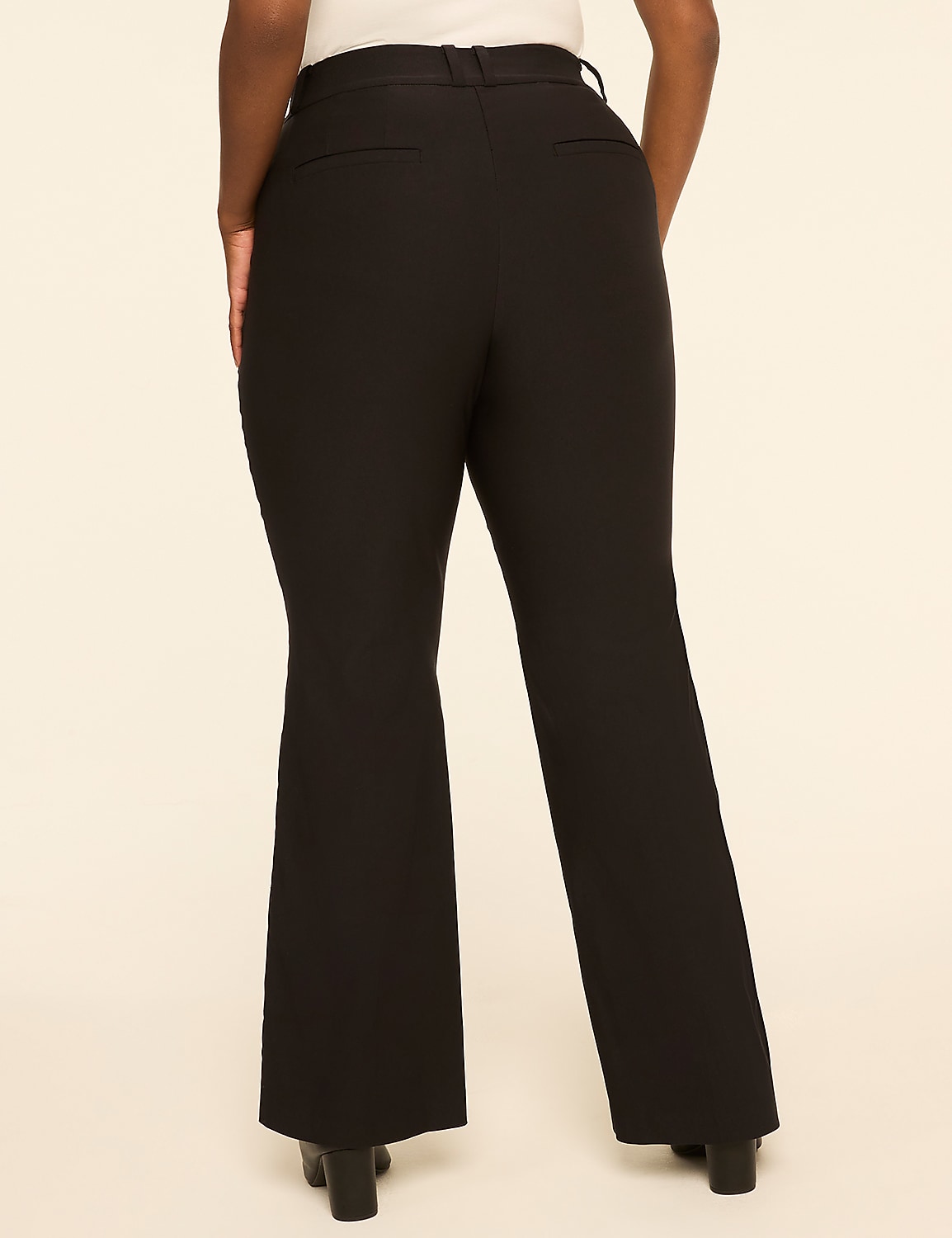 A person wearing black flared pants stands against a plain, light-colored background. Product Image 2