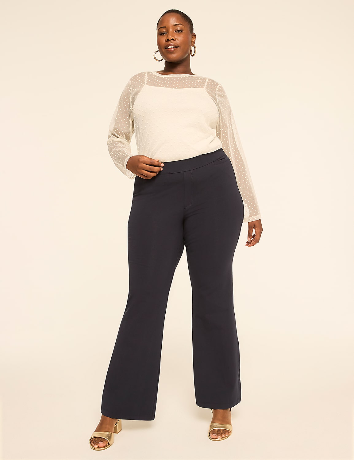 A woman in a white sheer top and dark pants stands against a plain, light-colored background. Product Image 3
