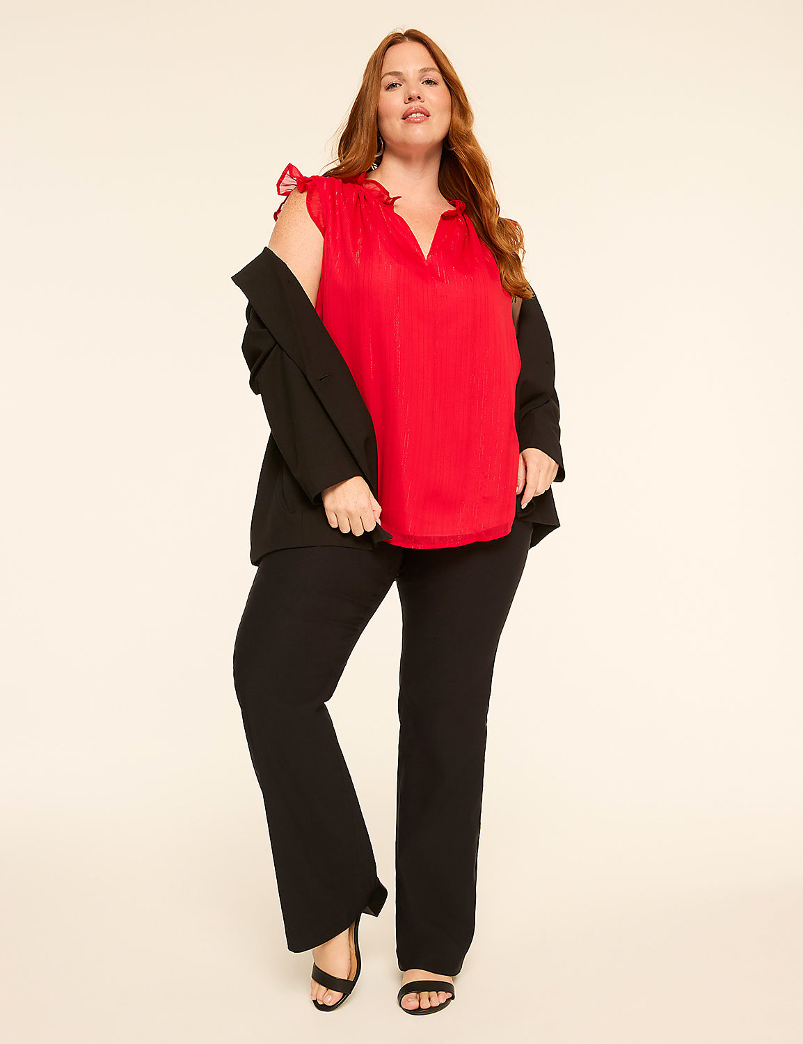 A woman in a red top and black pants stands against a plain, light-colored background. Product Image 3