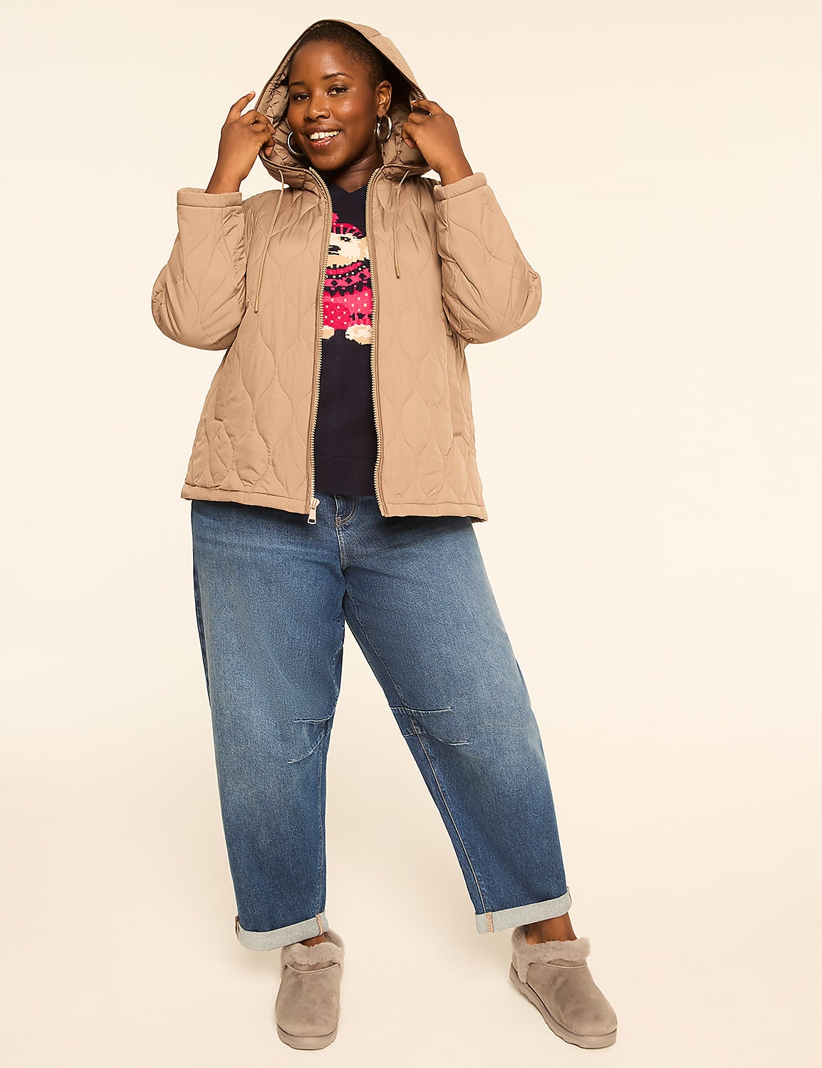 A woman in a tan quilted jacket and blue jeans smiles at the camera against a plain cream background. Product Image 3