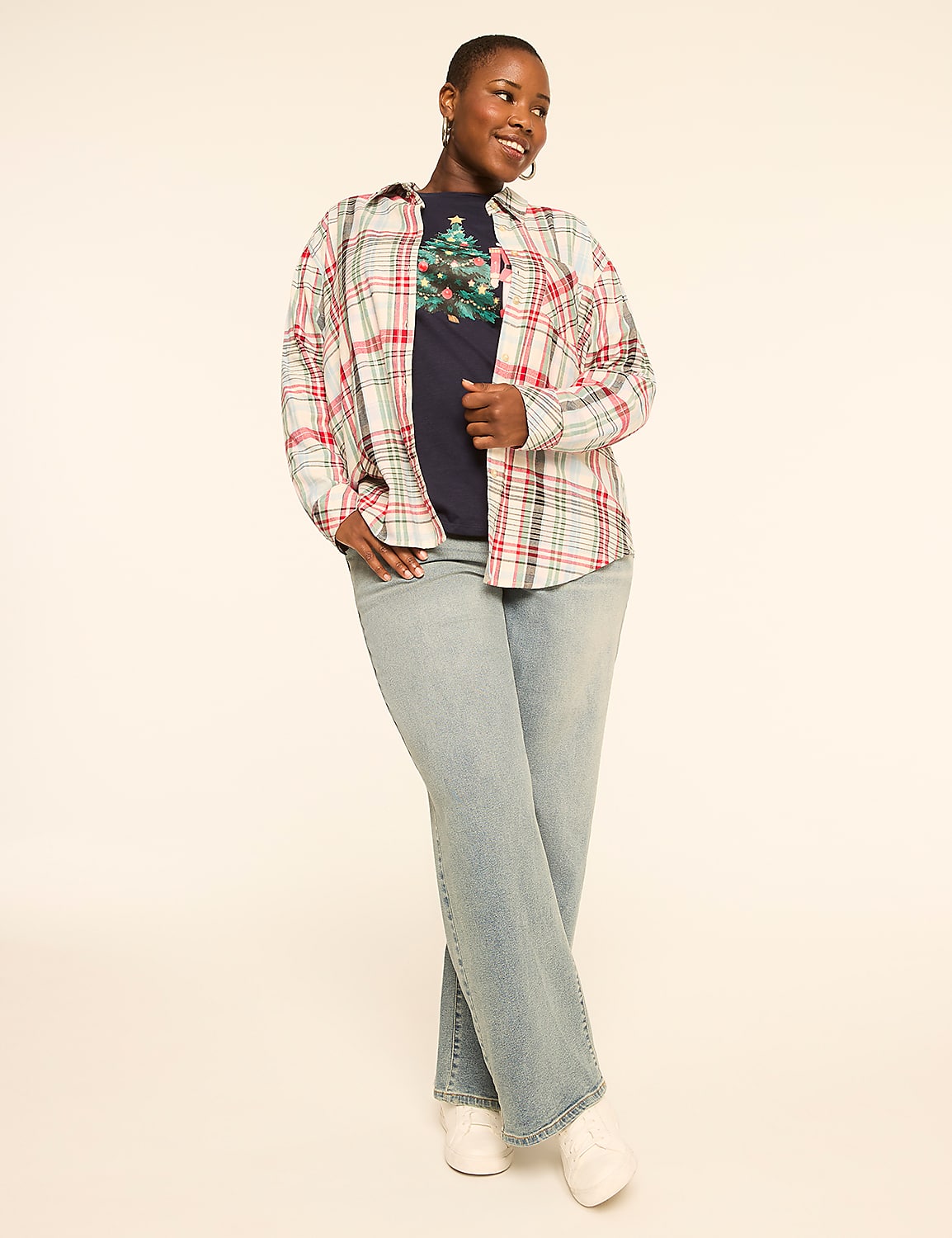 A woman in a plaid shirt and jeans stands against a plain, light-colored background. Product Image 3