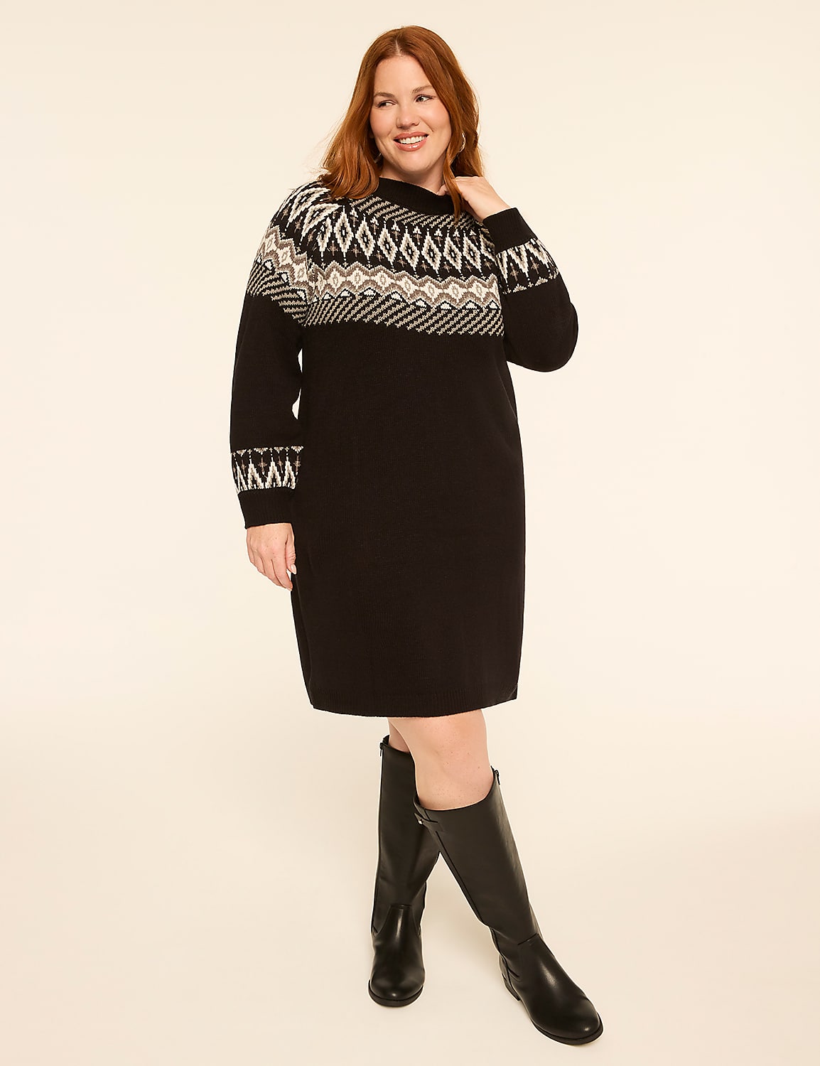 A woman in a black dress with a fair isle pattern stands against a plain, light-colored background. Product Image 1
