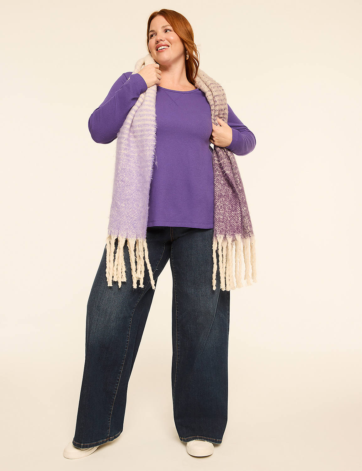 A woman in a purple shirt and jeans poses in front of a plain, light-colored background. Product Image 3