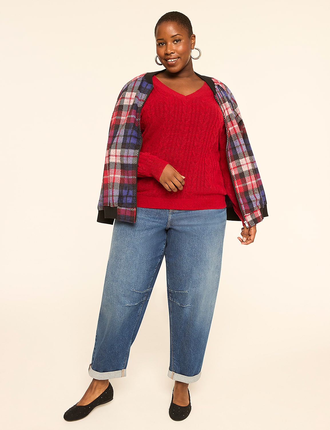 A woman in a red sweater, plaid jacket, and jeans stands against a plain, light-colored background. Product Image 3