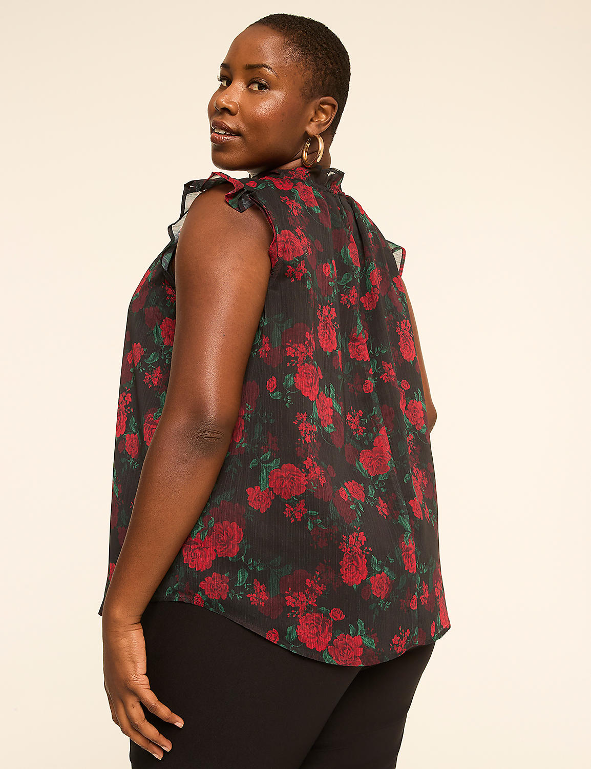 A woman in a floral top stands against a plain, light-colored background. Product Image 2