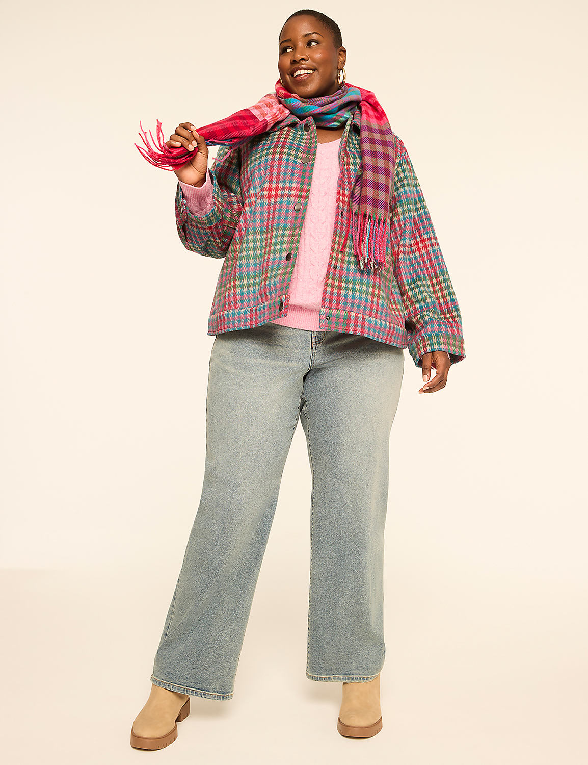 A smiling woman in a plaid jacket and jeans stands against a plain, light-colored background. Product Image 3