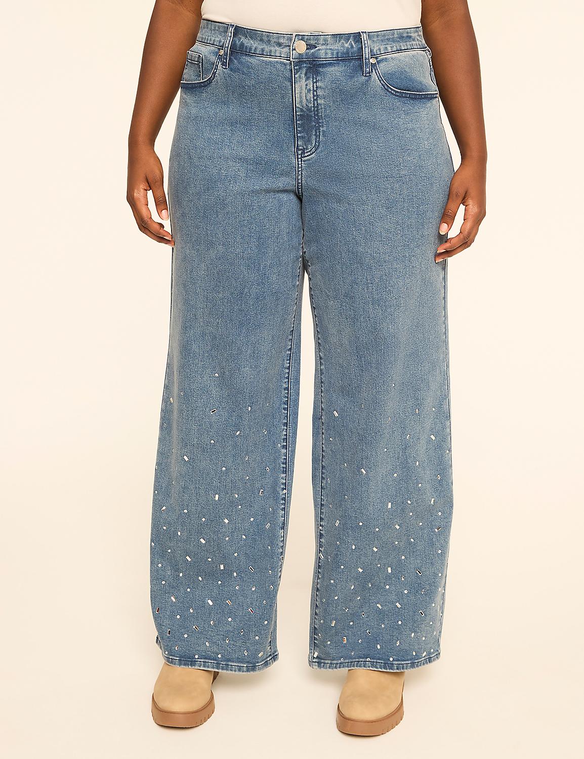 A person stands in light-wash wide-leg jeans adorned with scattered rhinestones, against a plain beige background. Product Image 1