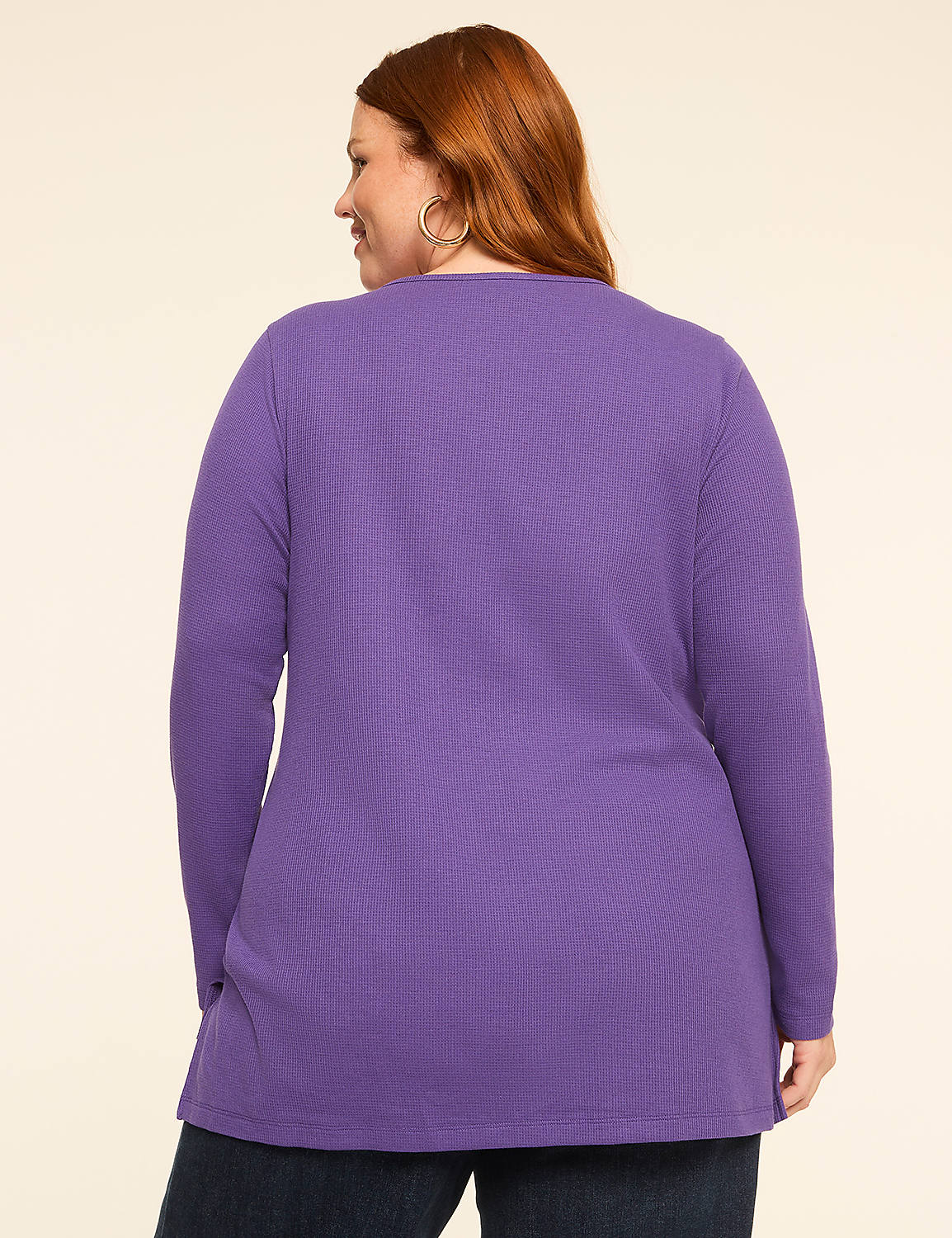 A woman with red hair wearing a purple long-sleeved shirt stands against a plain, light-colored background. Product Image 2