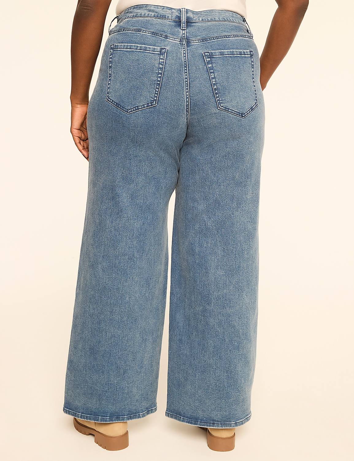 A person wearing wide-leg blue jeans stands against a plain, light-colored background. Product Image 2