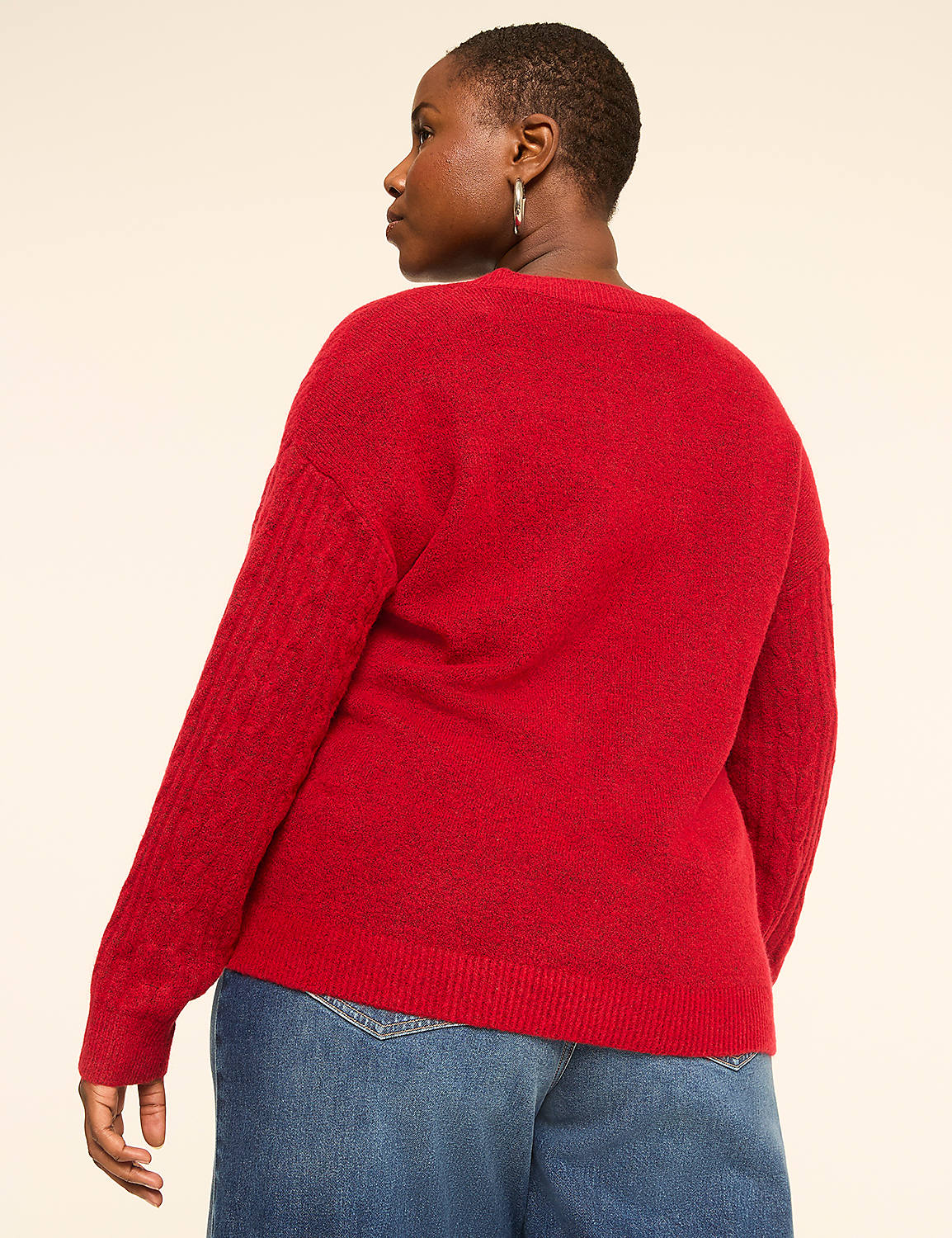 A woman in a red sweater and blue jeans stands against a plain, light-colored background. Product Image 2