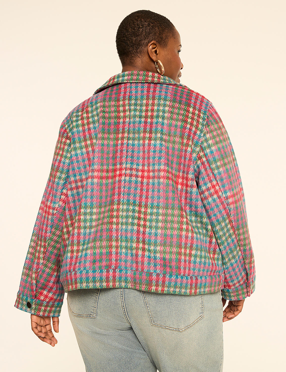 A woman wearing a colorful plaid jacket and light blue jeans stands against a plain, light-colored background. Product Image 2
