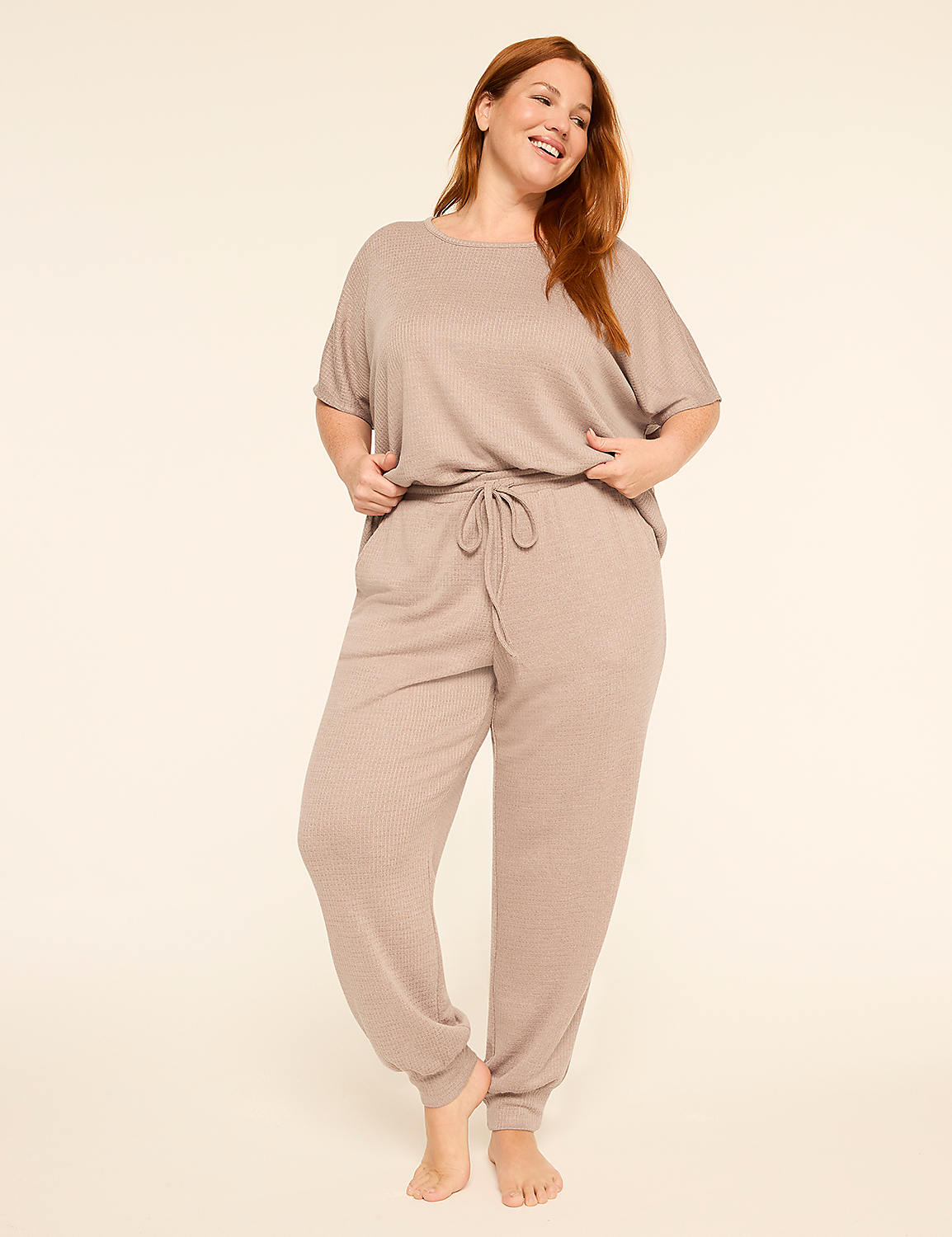 A smiling woman in a beige loungewear set stands against a plain, light background. Product Image 3