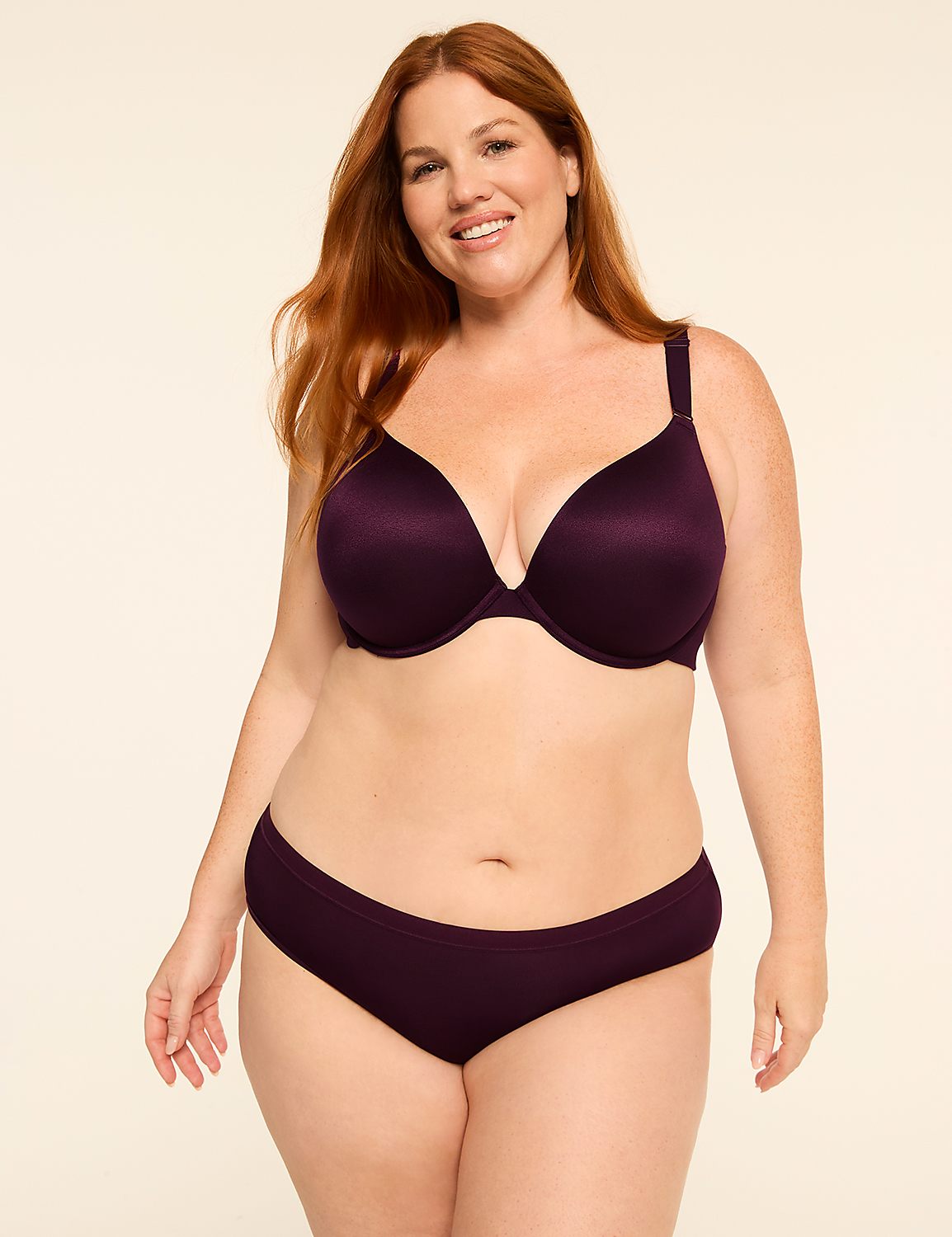 A smiling, red-haired woman in a purple bra and matching underwear stands against a plain, light-colored background. Product Image 4