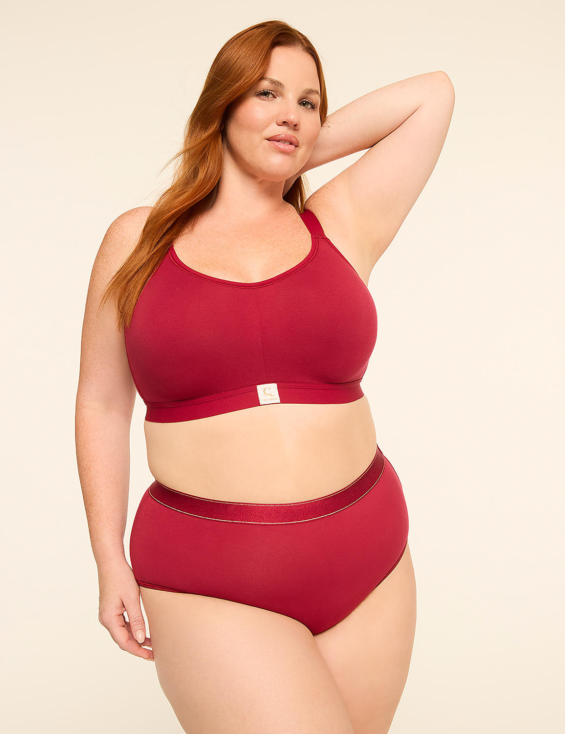 A red-haired woman in a maroon bra and matching high-waisted underwear poses against a plain, light-colored background. Product Image 4