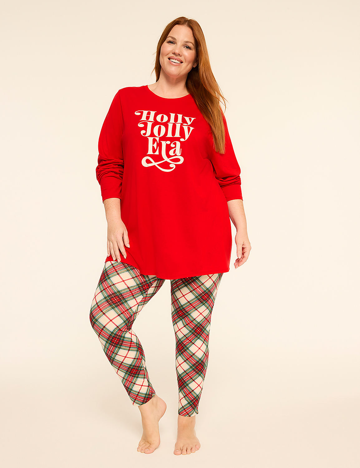 A woman in a red "Holly Jolly Era" sweater and plaid leggings stands against a plain, light background. Product Image 1